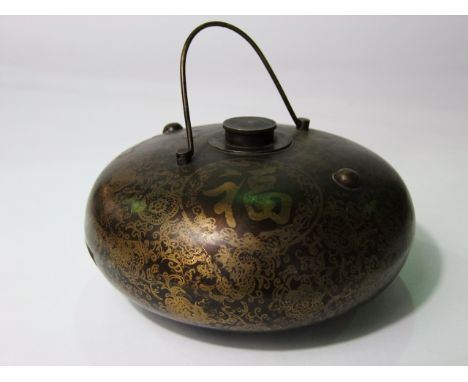 An old Japanese metal work flask/bottle of squat bulbous form with central screwing cap and looping hanging handle with patin