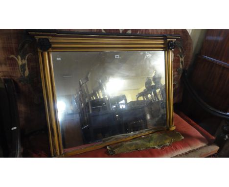 A Regency overmantle mirror of rectangular form, the cushion moulded frame with  gilded finish and further ebonised Tudor Ros