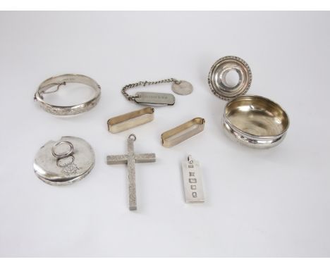 A collection of silver including an engraved cross, ingot, plain bangle, nozzle and jam pot lid, 135 gms total, together with