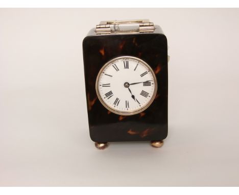 A tortoiseshell and silver mounted mantle clock with enamelled dial and eight day striking movement, silver hallmarked London