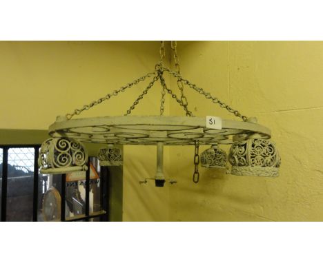 A hanging ironwork ceiling light of  circular form with scrollwork detail supporting five fittings, four outer with open inve