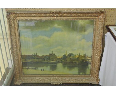 A colour print of a 17th century style Dutch townscape with river, figures etc in a substantial moulded gilt frame 91 x 105cm