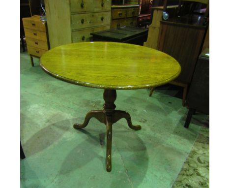 A good quality Georgian style tripod table, the circular top with moulded outline, raised on a turned pillar