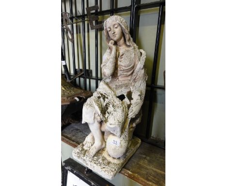 A weathered moulded plaster ornament in the form of a seated female holding a lute or mandolin, incised lettering to base Mig