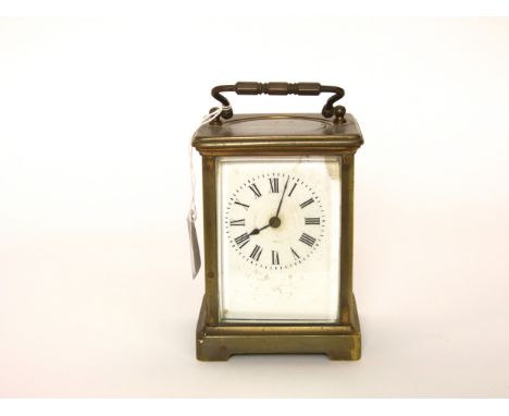 A simple brass carriage clock with eight day timepiece