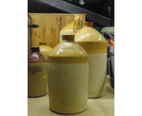A vintage stoneware flagon with impressed merchants mark for W Rogers Grocer, Golden  Key, Wotton Under Edge, together with f