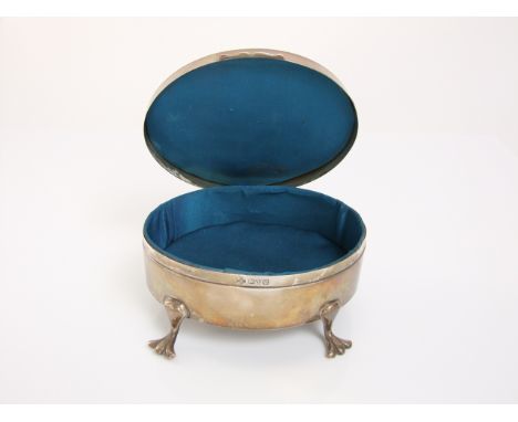 An oval silver jewel casket with engine turned cover, raised on four shaped supports, Chester 1920