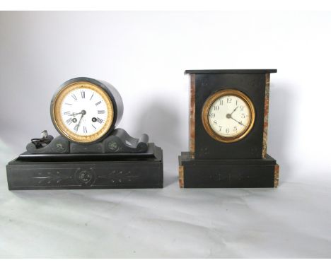 A Victorian black slate mantle clock, the drum movement set within a circular case raised on a scrolled base enclosing an eig