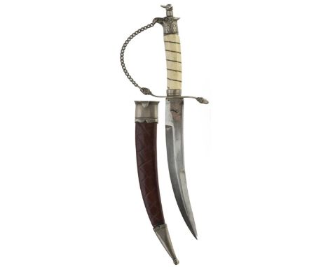 A late 19th Century dirk, 19cm sharply curved clipped back blade, the white metal mounted hilt with eagle pommel, white compo