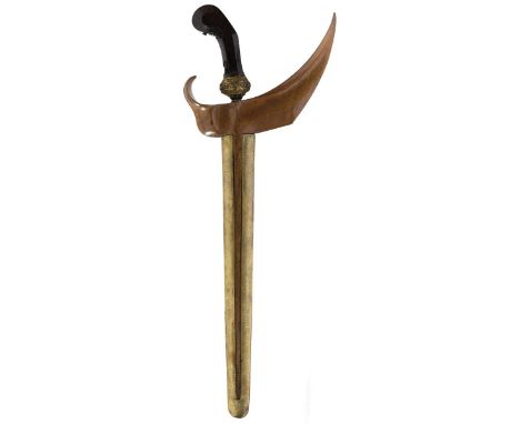 An early 20th Century kris, 33.5cm watered steel blade, characteristic sparsely carved wooden hilt with ornate gilt filigree 