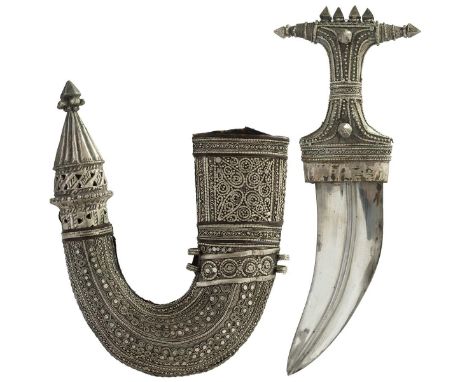 A white metal mounted Jambiya, 16cm sharply curved blade with raised medial ridge, characteristic white metal hilt, contained