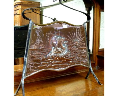 A copper Arts and Crafts fire screen, repousse decoration of a Viking galleon in full sail, the setting sun behind, with wrou