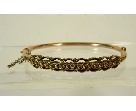 A Victorian hollow 9ct rose gold bangle with panel of cannetile decoration, 5.9g