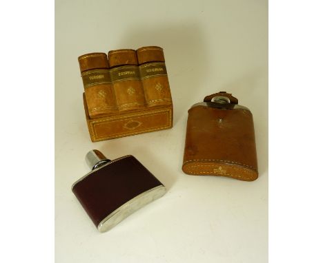 A 20th Century shaped glass hip flask with plated top and in pigskin holder; a modern hip flask and a three section cigarette