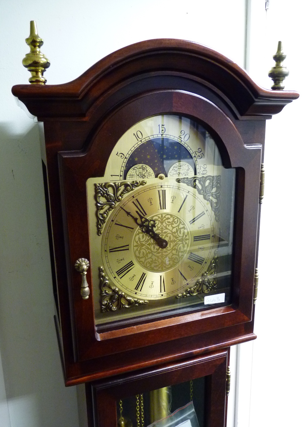 A modern grandmother clock, in mahogany case. The arched dial marked