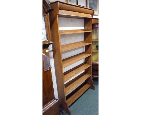 A late Victorian oak, open, six shelf bookcase.  The fixed shelves with narrow back rails.  Retailer's label for " BIDDICK & 