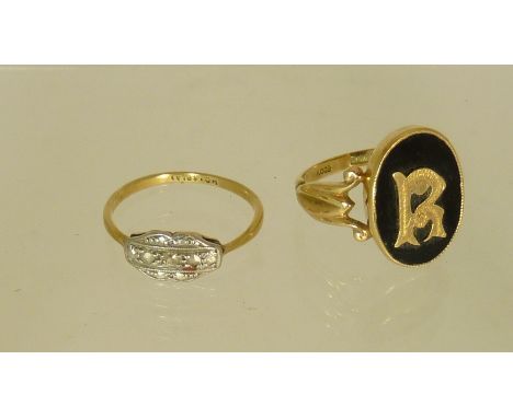 A 9ct gold signet ring set with an oval black onyx panel with applied gold initial "R", having openwork shoulders, size M and