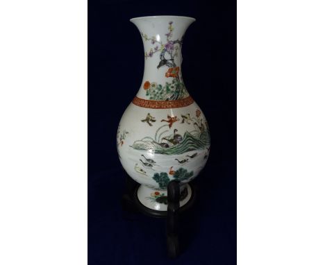 A Chinese porcelain vase painted with birds perched on prunus branches above scene of geese flying, standing amongst rocks an