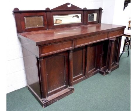 A Victorian mahogany sideboard, the inverted breakfront base fitted pillared doors to either and one cupboard fitted with a d