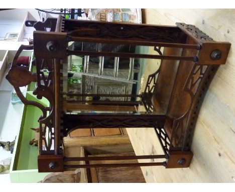 An early 20th century fret-cut hanging wall shelf, with mirrored back, two shelves, fret-cut galleried shelf. 33cm wide x 16c