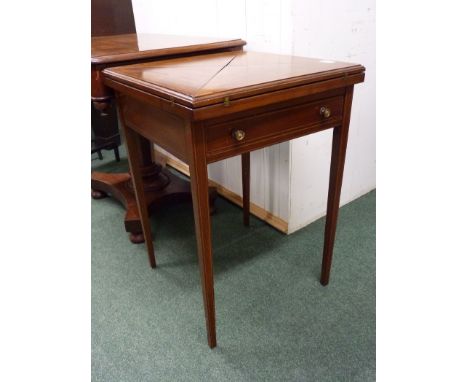 An Edwardian inlaid envelope card table.  The top cross banded, the sections opening to reveal a baize lined top, the section