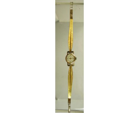 A ladies "Mudu" 18k gold cased wristwatch on a plated metal strap, manual wind, white dial with gold baton and arabic numeral
