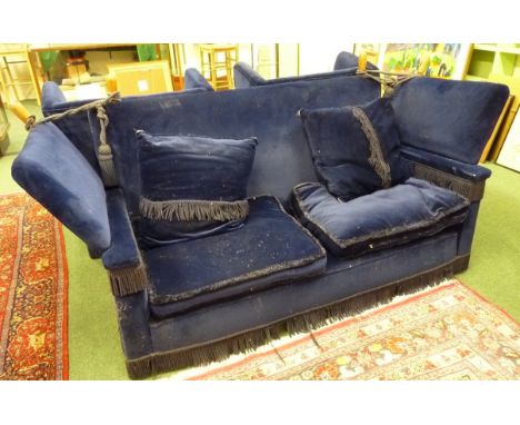 A blue upholstered Knole sofa and pair of matching armchairs, fringed to the arm supports and bases, matching cushions (uphol