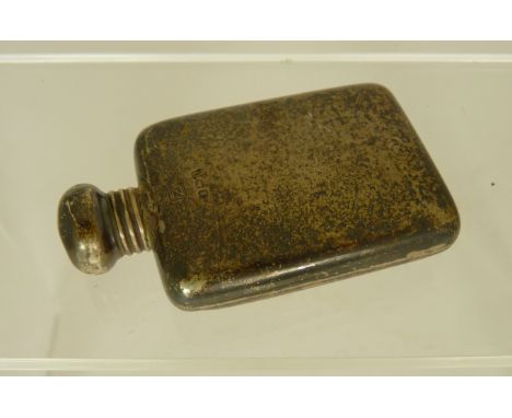 A small silver scent bottle, in the form of a hip flask, hallmarked Birmingham 1913? date letter worn.  Screw off cap. 