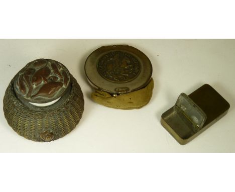A novelty brass and copper inkwell in the form of a fishing creel, the hinged cover embossed with assorted fish and a lobster