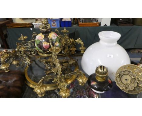 A Brass and Ceramic Rise and Fall Ceiling Chandelier with Nine Candle Holders and Central Oil Lamp
