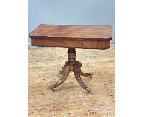 A Regency mahogany D-shaped foldover tea table, with swivel top and plain frieze, on ring-turned column and carved acanthus l