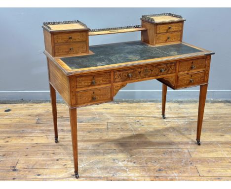 An Edwardian Sheraton Revival boxwood-inlaid satinwood kneehole desk, with brass gallery back and two pairs of stationery dra