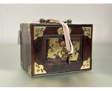 A Chinese brass-mounted hardwood cased mahjong set, with fall front, brass corner and further mounts, the fitted interior con