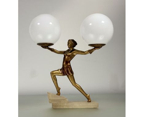 An Art Deco gilt-metal figural table lamp, modelled as a young female dancer in dynamic pose, each outstretched arm supportin