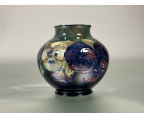 William Moorcroft, a spherical vase in the Pansies pattern, c. 1930, the short neck with everted rim, tubelined and painted w