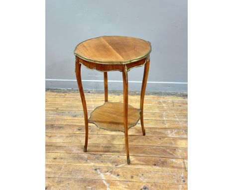 A French pale mahogany lamp table, late 19th century, of circular scalloped form with bronze mounts to the top and the scallo