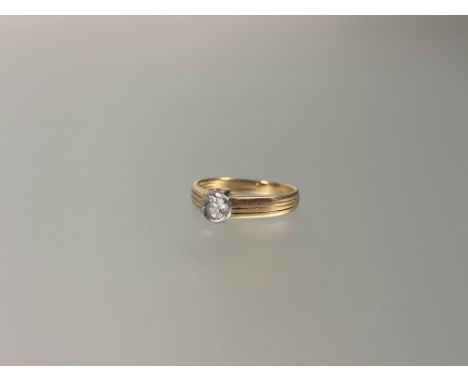 &nbsp;A single stone diamond ring, the round brilliant-cut stone (approx. 0.5ct) set on a reeded tapering yellow metal band (
