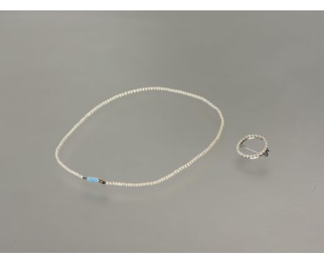 Property of a Lady of Title: a single strand graduated cultured seed pearl necklace, mid-20th century, on a powder blue ename