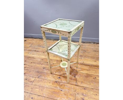 A painted mahogany bedside table in the Sheraton style, the buttermilk ground with all-over decoration of harebells and ribbo