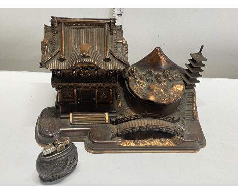 A unusual vintage musical copper and brass desktop cigarette dispenser with ashtray and a vintage table top lighter