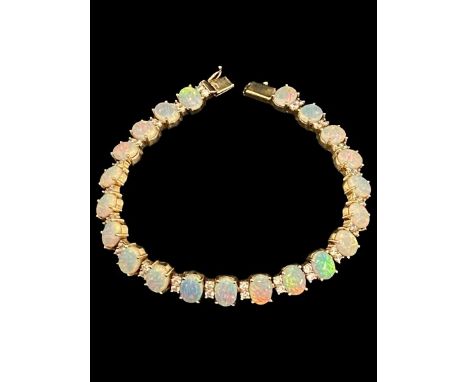 A quality white opal cabochon flashing blue, violet, red and green, bracelet set in 14ct gold.&nbsp; With intergrated white s