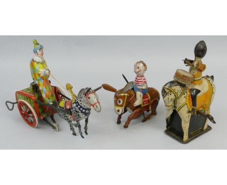 A Brimtoy tin-plate clockwork model of a military drummer on horseback, 15cm high and two other tin-plate clockwork models of