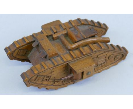 A scratch built beech model of a WWII tank, with carved features and exhaust pipe 14.5cm long