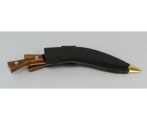 A modern Kukri, with 30.5cm steel blade, hardwood split grip and leather scabbard with two skinning knives 46cm overall