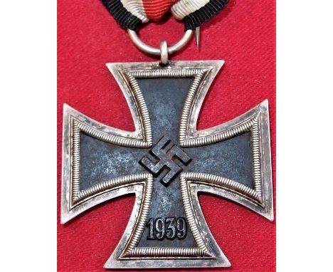 WW2 German Iron Cross 2nd Class medal with ribbon, with award badges to ribbon. 44mm wide cross arms, central magnetic iron c