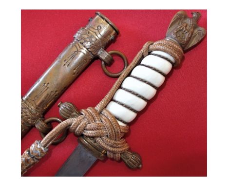 Pre-war made piece, with gilded brass fittings, with twisted wire white grip and eagle pommel. Gold bullion full knot tied to