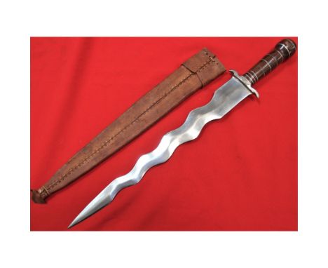 Shaped wooden grip, with white metal guard &amp; 42cm long swirling double edged blade. Comes with hand made leather scabbard