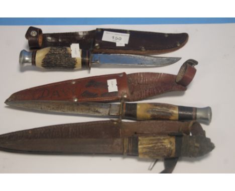 THREE VINTAGE ANTLER GRIP HUNTING KNIVES IN LEATHER SHEATHS (3)