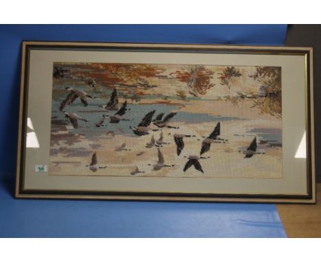 A TAPESTRY PICTURE OF CANADIAN GEESE ALONG WITH A FIRESCREEN 