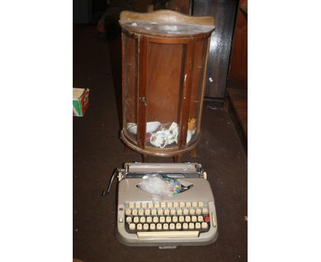 A MINIATURE CHINA CABINET AND A VINTAGE TYPEWRITER